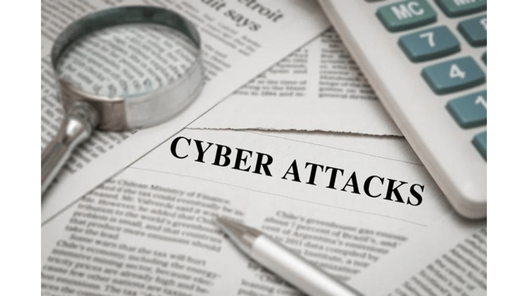 cyber attacks newspaper article with magnifying glass and pen