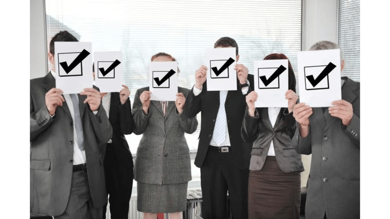 business people holding an image of checked off boxes