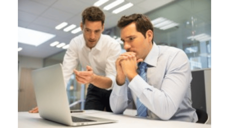 2 business men looking at computer screen IT budget