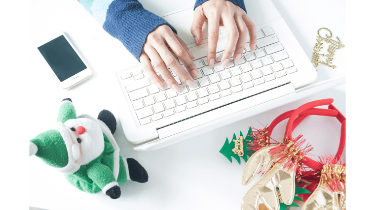 person typing on computer holiday season IT best practices