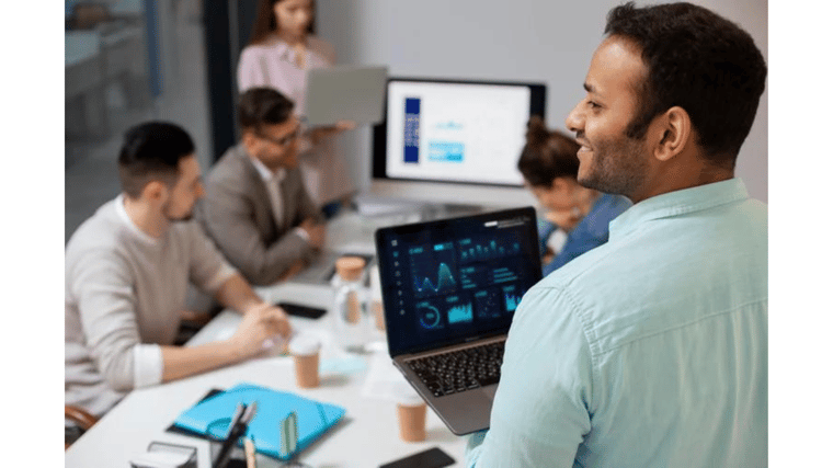 man overseeing a group of people at computers outsourced IT