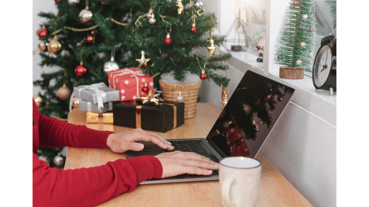 person on computer with Christmas season holiday AI navigating holidays with AI