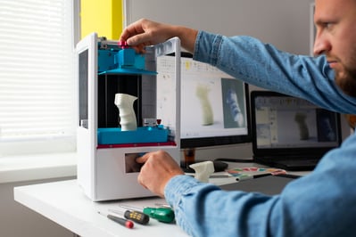 designer using a 3D printer additive manufacturing