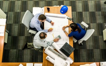 group of construction design workers at table with AI