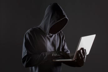 side-view-male-hacker-with-gloves-laptop